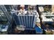 Aerial view of a modern high-rise building with a pool and city backdrop at 860 Peachtree Ne St # 1617, Atlanta, GA 30308