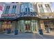 Modern building entrance with prominent signage and retail spaces at 860 Peachtree Ne St # 1617, Atlanta, GA 30308