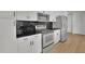 Modern kitchen with stainless steel appliances and dark tile backsplash at 860 Peachtree Ne St # 1617, Atlanta, GA 30308