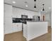 Modern kitchen with island, stainless steel appliances, and white cabinets at 860 Peachtree Ne St # 1617, Atlanta, GA 30308