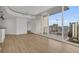 Open living area with hardwood floors and access to a balcony at 860 Peachtree Ne St # 1617, Atlanta, GA 30308