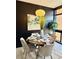 Cozy dining room with modern lighting, round table, and seating for four with dark accent wall at 972 Dekalb Ne Ave # 203, Atlanta, GA 30307