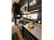 Modern kitchen featuring stainless steel appliances, granite countertops, and sleek, dark cabinetry at 972 Dekalb Ne Ave # 203, Atlanta, GA 30307