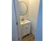 Small bathroom with white vanity, gold fixtures, and a round mirror at 1217 Eagles Nest Cir, Carrollton, GA 30116
