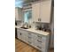 White kitchen cabinets, quartz countertops, and a farmhouse sink at 1217 Eagles Nest Cir, Carrollton, GA 30116