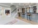 Basement wet bar with seating for three at 3352 Forest Vista Dr, Dacula, GA 30019