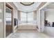 Bathroom with corner soaking tub, walk-in shower, and window with natural light at 3352 Forest Vista Dr, Dacula, GA 30019