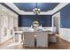 Formal dining room with navy walls, hardwood floors, and a chandelier at 3352 Forest Vista Dr, Dacula, GA 30019