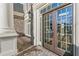 Double front doors with a charming doormat and brick pathway at 3352 Forest Vista Dr, Dacula, GA 30019