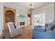 Bright Gathering room with hardwood floors, fireplace, and built-in cabinetry at 3352 Forest Vista Dr, Dacula, GA 30019