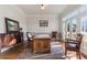 Bright home office features hardwood floors, built-in shelving, and French doors leading to a balcony at 3352 Forest Vista Dr, Dacula, GA 30019