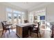 Sunlit home office with hardwood floors, large windows, and view into adjacent living area at 3352 Forest Vista Dr, Dacula, GA 30019