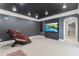Basement home theater with TV, seating, and access to other rooms at 3352 Forest Vista Dr, Dacula, GA 30019
