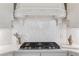 Luxury kitchen with marble backsplash and high-end gas cooktop at 3352 Forest Vista Dr, Dacula, GA 30019