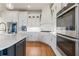Modern kitchen with white cabinets, stainless steel appliances, and hardwood floors at 3352 Forest Vista Dr, Dacula, GA 30019