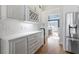 White kitchen cabinetry, quartz countertops, and a wine rack at 3352 Forest Vista Dr, Dacula, GA 30019