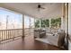 Relaxing covered porch with wooden flooring, wicker furniture, and scenic wooded views at 3352 Forest Vista Dr, Dacula, GA 30019