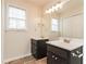 Bathroom featuring double sink vanity, a large mirror, and a window for natural light at 2808 Mountbery Dr, Snellville, GA 30039