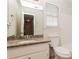 Bathroom with granite countertop vanity, sink, toilet, and mirror at 2808 Mountbery Dr, Snellville, GA 30039