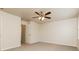 Neutral-toned bedroom with carpeted floors and a ceiling fan, offering plenty of space at 2808 Mountbery Dr, Snellville, GA 30039