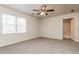 Carpeted bedroom with a ceiling fan, natural light, and an attached bathroom at 2808 Mountbery Dr, Snellville, GA 30039