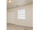 Bright carpeted bedroom with closet space and a window for natural light at 2808 Mountbery Dr, Snellville, GA 30039