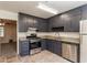 Modern kitchen with gray cabinets, stainless steel appliances, and tile floors at 2808 Mountbery Dr, Snellville, GA 30039