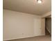 Neutral living room featuring plush carpet, a textured ceiling, and an entrance to the stairwell at 2808 Mountbery Dr, Snellville, GA 30039