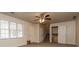 Bright and airy living room with large windows, carpet floors, and a ceiling fan at 2808 Mountbery Dr, Snellville, GA 30039