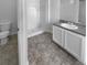 Bathroom with white vanity, shower, and gray tile flooring at 5165 Hanover St, Atlanta, GA 30349