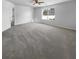 Spacious bedroom with gray carpeting and large window at 5165 Hanover St, Atlanta, GA 30349