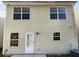 Rear view of tan house with white door and multiple windows at 5165 Hanover St, Atlanta, GA 30349