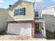 Two-story house with a white garage door and brick base at 5165 Hanover St, Atlanta, GA 30349