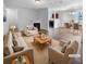 Virtually staged living room with beige sofas and a fireplace at 5165 Hanover St, Atlanta, GA 30349
