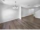 Spacious living room with wood-look floors and access to the hallway at 5165 Hanover St, Atlanta, GA 30349