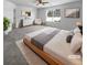 Virtually staged main bedroom with large bed and gray carpet at 5165 Hanover St, Atlanta, GA 30349