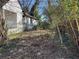 Exterior of a run-down, one-story house with overgrown landscaping in the backyard at 125 Martin Se Ave, Atlanta, GA 30315