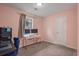 Bright bedroom with window, workspace, and neutral walls at 3590 Ashley Woods Dr, Powder Springs, GA 30127