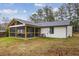 Backyard view of home with screened porch addition at 3590 Ashley Woods Dr, Powder Springs, GA 30127