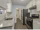 Updated kitchen with granite countertops, stainless steel appliances, and white cabinets at 3590 Ashley Woods Dr, Powder Springs, GA 30127