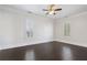 Bedroom with hardwood floors, neutral walls, and bright windows with white shutters and ample natural light at 6725 Cross Gate St, Cumming, GA 30040