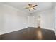 Spacious bedroom features hardwood floors, neutral walls, a ceiling fan, and a doorway to the bathroom at 6725 Cross Gate St, Cumming, GA 30040