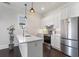 Bright kitchen with stainless steel appliances, white cabinets, quartz countertops, and modern pendant lighting at 6725 Cross Gate St, Cumming, GA 30040