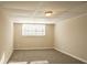 Bright basement bedroom featuring a large window and neutral wall tones at 2668 Woodfen Dr, Ellenwood, GA 30294