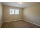 Well-lit bedroom with neutral walls and carpet flooring at 2668 Woodfen Dr, Ellenwood, GA 30294