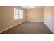 Well-lit bedroom with neutral walls and carpet at 2668 Woodfen Dr, Ellenwood, GA 30294