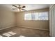 Bright bedroom featuring a ceiling fan and carpet flooring at 2668 Woodfen Dr, Ellenwood, GA 30294