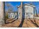Gray two-story house with a large yard and mature trees at 2668 Woodfen Dr, Ellenwood, GA 30294
