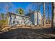 Gray two-story house with large windows and mature trees at 2668 Woodfen Dr, Ellenwood, GA 30294