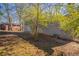 Side view of gray brick house showing landscaping and yard at 2668 Woodfen Dr, Ellenwood, GA 30294